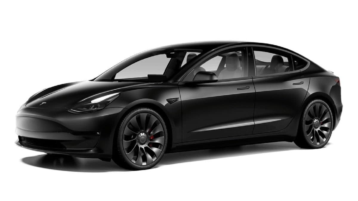 Sleek black Tesla Model 3 Performance electric sedan featuring dark wheels and red calipers.