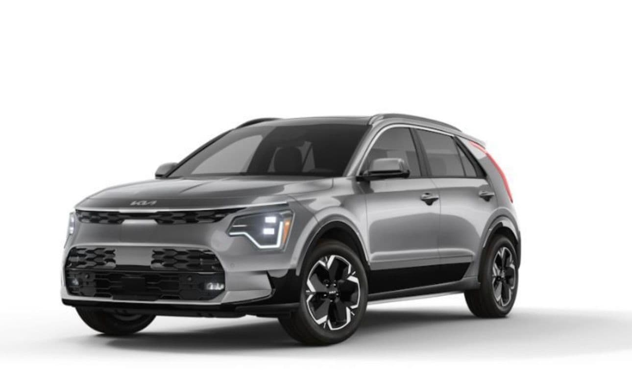 Sleek silver Kia Niro crossover with black trim and modern LED headlights against white.
